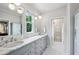 Bright bathroom featuring dual sinks, marble counters, and a glass enclosed walk-in shower at 111 Terrace Ne Dr, Atlanta, GA 30305