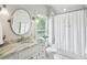 Bright bathroom with a granite countertop, a decorative mirror, and a shower/tub combination at 111 Terrace Ne Dr, Atlanta, GA 30305