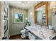 Updated half bath with wainscotting, modern fixtures, and marble countertop at 111 Terrace Ne Dr, Atlanta, GA 30305