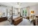 Bright bedroom featuring a four-poster bed, sitting area, and access to a private balcony at 111 Terrace Ne Dr, Atlanta, GA 30305