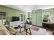Bedroom with a bed, workspace, television, hardwood floors, area rug, and a ceiling fan at 111 Terrace Ne Dr, Atlanta, GA 30305