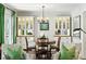 Elegant dining room with hardwood floors, stylish lighting, and built-in cabinets at 111 Terrace Ne Dr, Atlanta, GA 30305