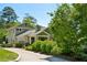 Beautiful exterior view of a two-story home showcasing a well-manicured lawn, mature trees, and a welcoming front porch at 111 Terrace Ne Dr, Atlanta, GA 30305