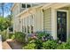 Charming exterior detail with beautiful flowers near the side entry and a glimpse of the home's architectural style at 111 Terrace Ne Dr, Atlanta, GA 30305
