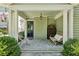 Inviting front porch with stone flooring, seating, and classic decor at 111 Terrace Ne Dr, Atlanta, GA 30305