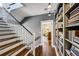 Hallway with staircase, bookshelf and view into the living room at 111 Terrace Ne Dr, Atlanta, GA 30305