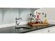 Wet bar area with a vintage style faucet, stone countertop and stocked shelving at 111 Terrace Ne Dr, Atlanta, GA 30305
