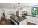 Bright white kitchen with eat-in island, black countertops and stainless steel appliances at 111 Terrace Ne Dr, Atlanta, GA 30305
