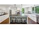 Modern kitchen with white cabinets, dark countertops, and a center island at 111 Terrace Ne Dr, Atlanta, GA 30305