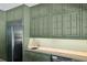 Kitchenette area with green cabinets, stainless steel refrigerator, butcher block countertop, and a small sink at 111 Terrace Ne Dr, Atlanta, GA 30305