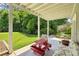 Outdoor patio area overlooking a green lawn and featuring outdoor seating on a covered concrete patio at 111 Terrace Ne Dr, Atlanta, GA 30305