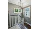 Stylish stairway with modern lighting fixture, wood steps and white railings, providing a sleek transition at 111 Terrace Ne Dr, Atlanta, GA 30305