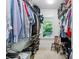 Well-organized walk-in closet with ample hanging space, shelving, and a window for natural light at 111 Terrace Ne Dr, Atlanta, GA 30305