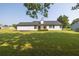 The back of the house with a well-maintained green lawn and dark trim and white siding at 1510 Summer Lake Ter, Loganville, GA 30052