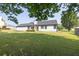 Beautifully maintained lawn behind the home with a white exterior and contrasting dark trim at 1510 Summer Lake Ter, Loganville, GA 30052