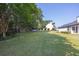 A spacious backyard with well-maintained grass, trees, and the back of the home at 1510 Summer Lake Ter, Loganville, GA 30052