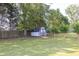 A white shed with black trim sits in the backyard, providing extra storage space at 1510 Summer Lake Ter, Loganville, GA 30052