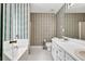 Charming bathroom with dual sinks, tub, and shower at 1510 Summer Lake Ter, Loganville, GA 30052