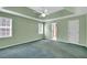 Spacious bedroom with tray ceiling, fan, and windows offering natural light at 1510 Summer Lake Ter, Loganville, GA 30052