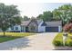 Single-story home with a stone facade and a spacious driveway leading to an attached garage at 1510 Summer Lake Ter, Loganville, GA 30052