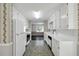 Functional kitchen featuring white appliances, ample counter space, and decorative wallpaper at 1510 Summer Lake Ter, Loganville, GA 30052