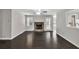 Bright living room with hardwood floors, a stone fireplace, and natural light from large windows at 1510 Summer Lake Ter, Loganville, GA 30052