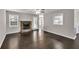 Elegant living room featuring a stone fireplace, hardwood floors, and an open floor plan at 1510 Summer Lake Ter, Loganville, GA 30052