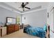 Comfortable bedroom with ceiling fan, a dresser, and a view to the outside at 154 Stephens Mill Dr, Dallas, GA 30157