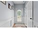 Inviting entryway featuring neutral paint, white wainscoting, and a stylish rug leading to a glass-paneled door at 154 Stephens Mill Dr, Dallas, GA 30157