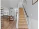 Open foyer with a carpeted staircase, hardwood floors, and a glimpse of the living area at 154 Stephens Mill Dr, Dallas, GA 30157