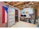 Finished basement featuring a custom bar area with sliding barn door, brick accent wall, and workspace at 2245 Long Bow Chase, Kennesaw, GA 30144