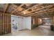 Spacious basement shows framing, door to living space, and potential for customization at 2245 Long Bow Chase, Kennesaw, GA 30144