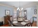 Dining room features an elegant chandelier, stylish decor, and a table set for a meal at 2245 Long Bow Chase, Kennesaw, GA 30144