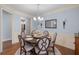 Elegant dining room featuring stylish chairs, decorative lighting, and wainscoting at 2245 Long Bow Chase, Kennesaw, GA 30144
