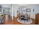 Light-filled dining room features hardwood floors, decorative wainscoting, and modern chandelier at 2245 Long Bow Chase, Kennesaw, GA 30144