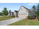 Charming home featuring a manicured lawn, long driveway, and neutral siding, showcasing curb appeal at 2245 Long Bow Chase, Kennesaw, GA 30144
