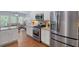 Bright kitchen with stainless steel appliances, granite countertops, and a view into the living area at 2245 Long Bow Chase, Kennesaw, GA 30144