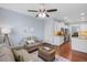 Cozy living room with hardwood floors, ceiling fan, and view to the kitchen area at 2245 Long Bow Chase, Kennesaw, GA 30144