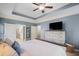 Main bedroom with ceiling fan, tray ceiling, and a dresser with decor at 2245 Long Bow Chase, Kennesaw, GA 30144