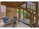 Cozy covered patio featuring wooden walls, stairs, stone pavers, and comfortable seating at 2245 Long Bow Chase, Kennesaw, GA 30144
