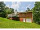 Exterior view of a brick home with a spacious backyard at 3223 Heritage Way, Buford, GA 30519