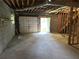 Unfinished basement with garage door access, providing convenient entry and ample storage opportunities at 3223 Heritage Way, Buford, GA 30519