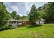 Charming single-Gathering home with a brick facade, inviting front porch, and a lush green lawn at 3223 Heritage Way, Buford, GA 30519