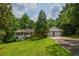 Charming single-Gathering home with a brick facade, inviting front porch, two-car garage, and a lush green lawn at 3223 Heritage Way, Buford, GA 30519