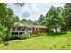 Charming single-Gathering home with a brick facade, inviting front porch, and a lush green lawn at 3223 Heritage Way, Buford, GA 30519