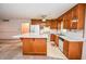 Well-lit kitchen with ample counter space and wood cabinetry at 3223 Heritage Way, Buford, GA 30519