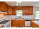 This classic kitchen has wood cabinets, sleek appliances and lots of counter space at 3223 Heritage Way, Buford, GA 30519
