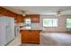 Open kitchen with wood cabinets, a center island, and large windows at 3223 Heritage Way, Buford, GA 30519