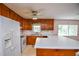 Bright kitchen boasts white countertops, wooden cabinets, and modern appliances at 3223 Heritage Way, Buford, GA 30519
