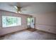 Inviting living room featuring a large bay window with backyard view and a front entry door at 3223 Heritage Way, Buford, GA 30519